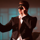 Stanton Carlisle (Bradley Cooper) wears a tuxedo and a blindfold with an eye emblazoned on it in Nightmare Alley.